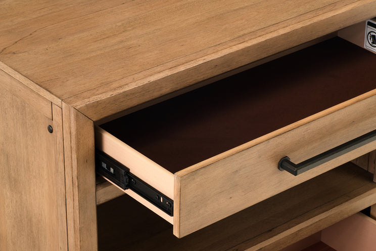 Wooden drawer being pulled out from a wooden cabinet.